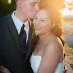 Backlit wedding portrait of newlyweds