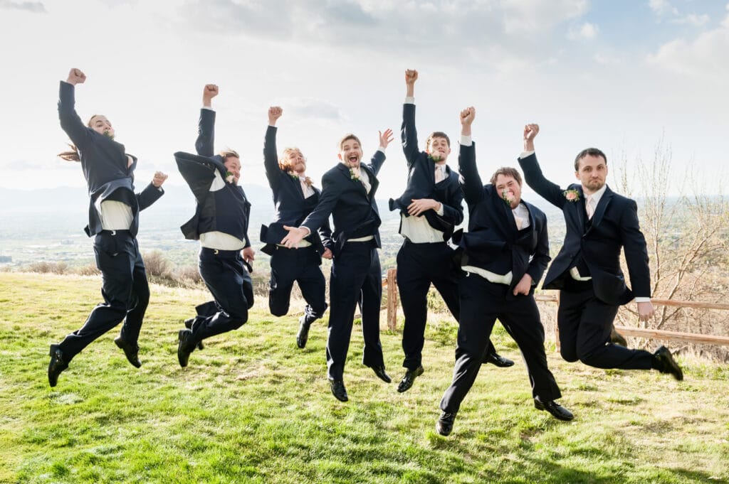 Jumping groom and groomsmen